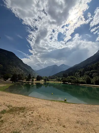 A mountain lake under a big sky of broken cloud.