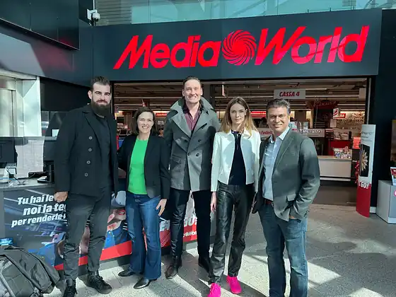 Five colleagues outside a MediaWorld store.