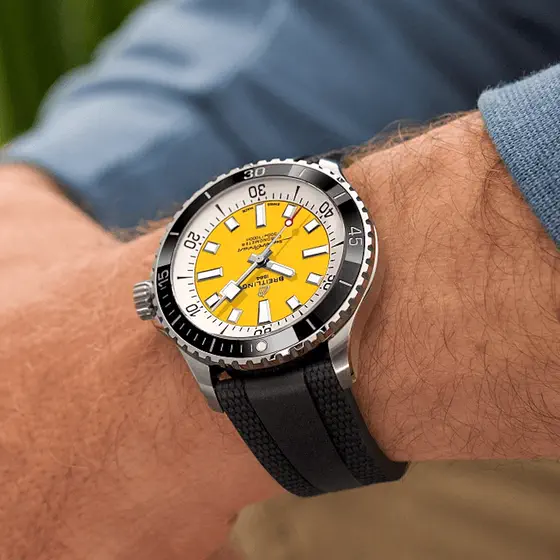 A Breitling Superocean with a yellow dial, worn on a wrist