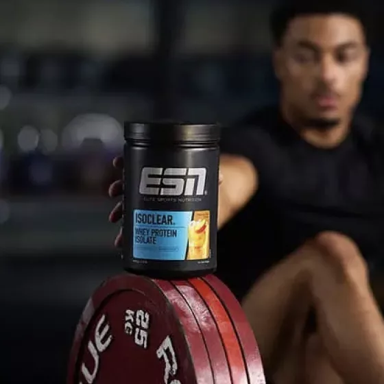 An ESN protein tub resting on a weight plate