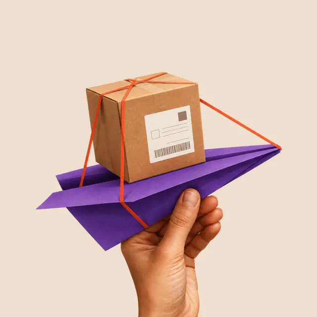 A cardboard parcel strapped to a folded purple paper plane