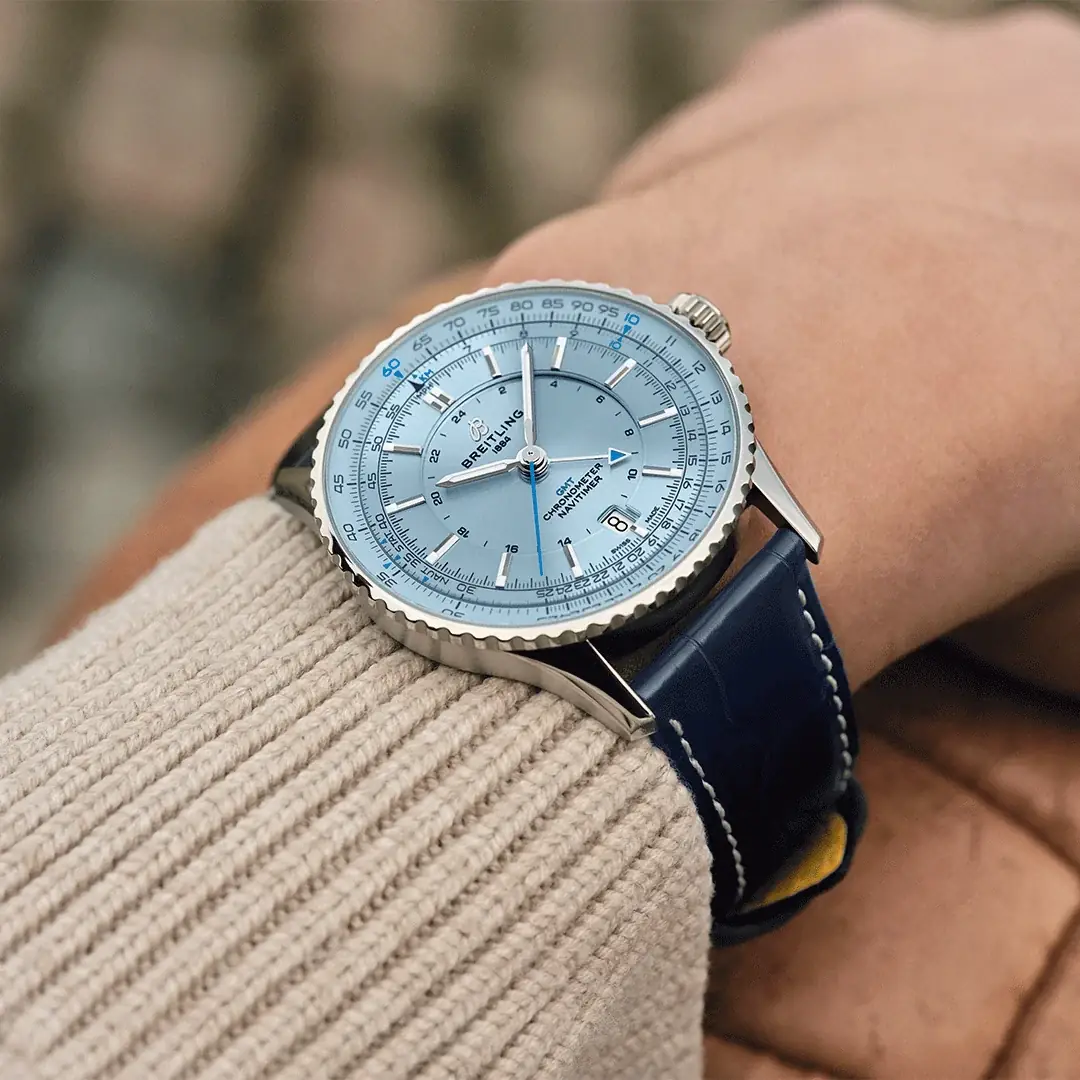 A Breitling Navitimer GMT with an ice-blue dial, worn on the wrist.