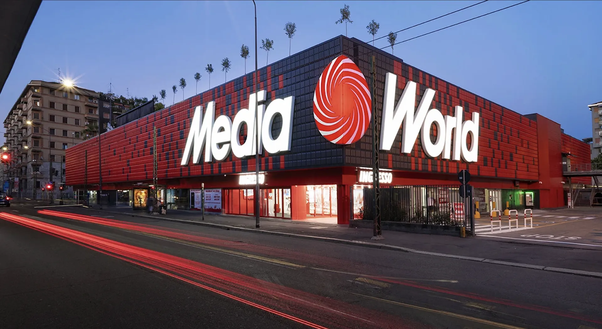 A MediaWorld store at dusk.