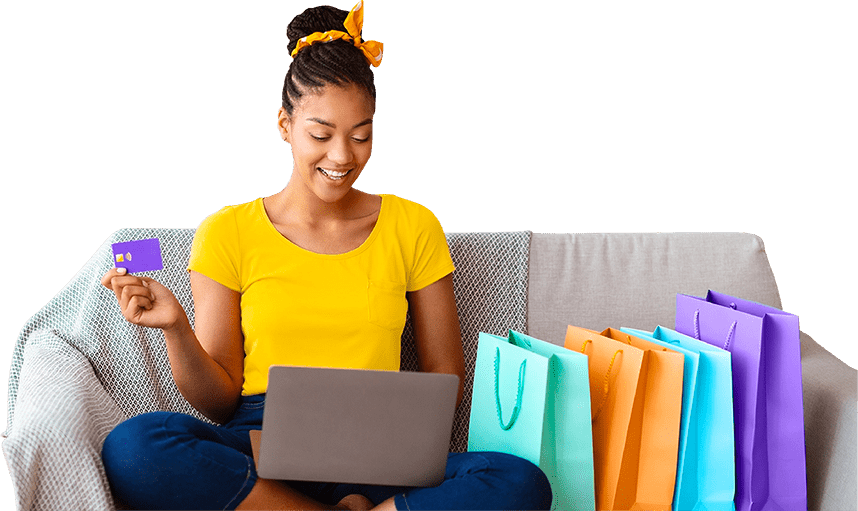 Woman sitting on couch with shopping bags